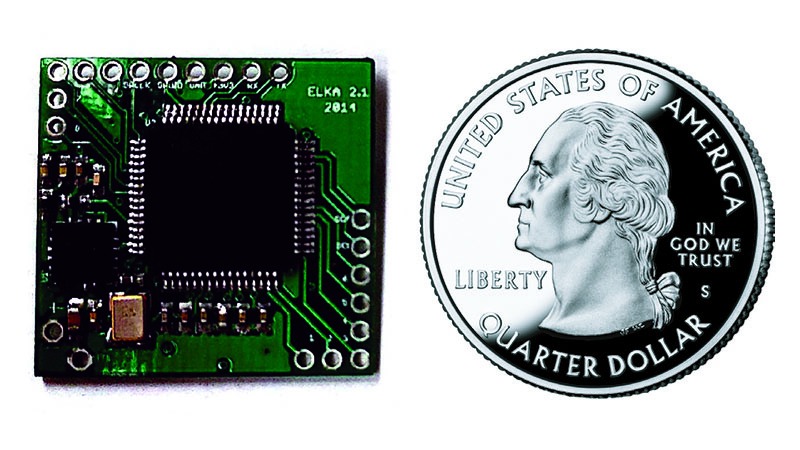 Electronic circuit board next to a u.s. quarter dollar coin, illustrating size comparison.