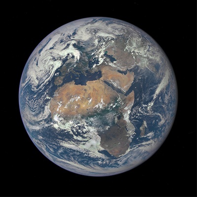 A view of Earth from space, showing continents, oceans, and cloud formations. Africa, Europe, and parts of Asia are clearly visible. The planet is surrounded by the blackness of space.
