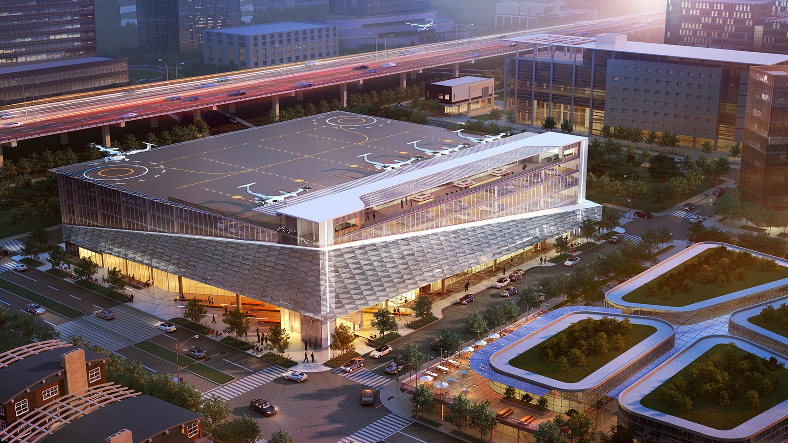 A modern building with a rooftop helicopter pad, surrounded by urban structures and roads with moving traffic in a cityscape at sunset.