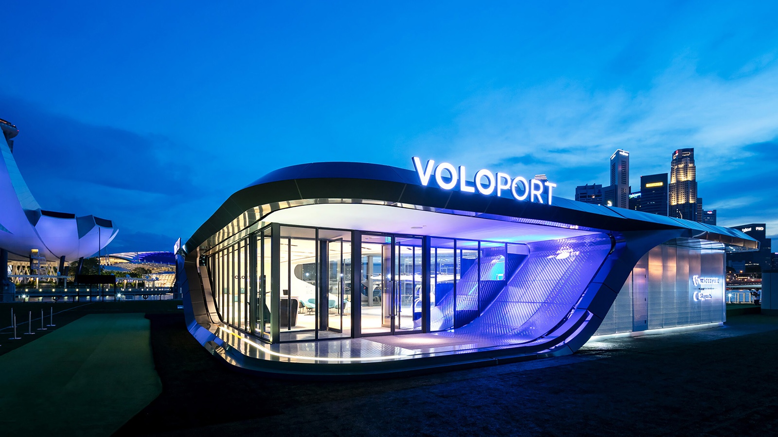 A modern, illuminated building labeled