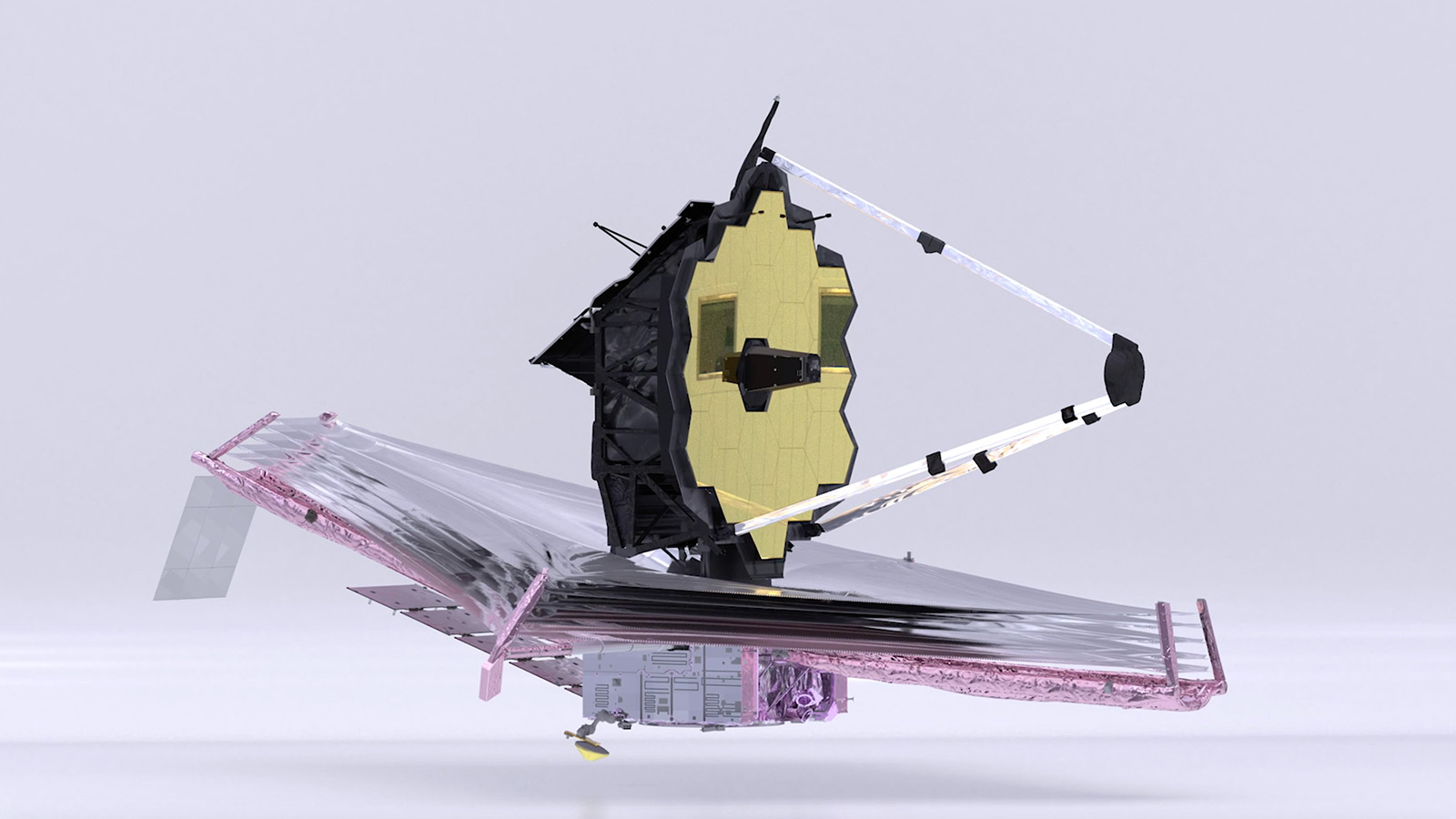 Image of the James Webb Space Telescope with its golden hexagonal mirror and large, kite-shaped sunshield. The telescope is fully deployed against a pale background.