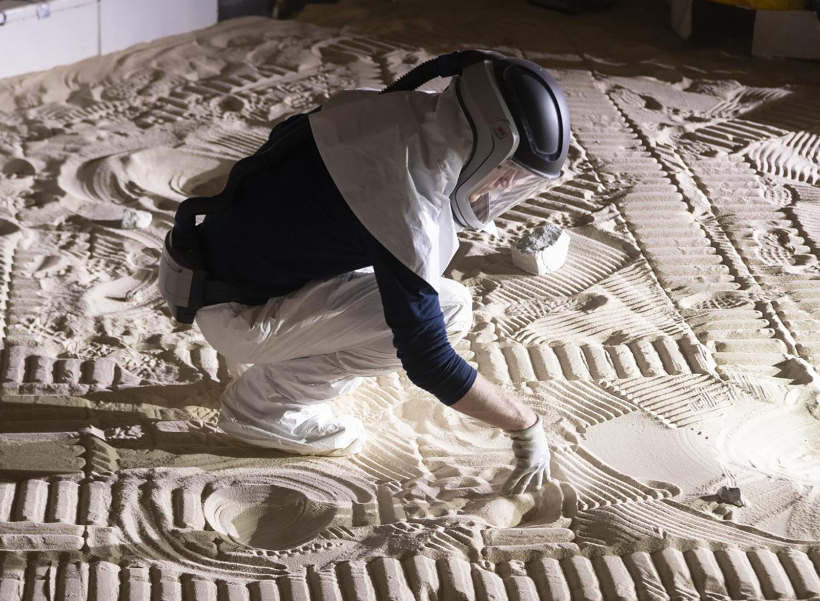 Engineer kneeling in sandbox